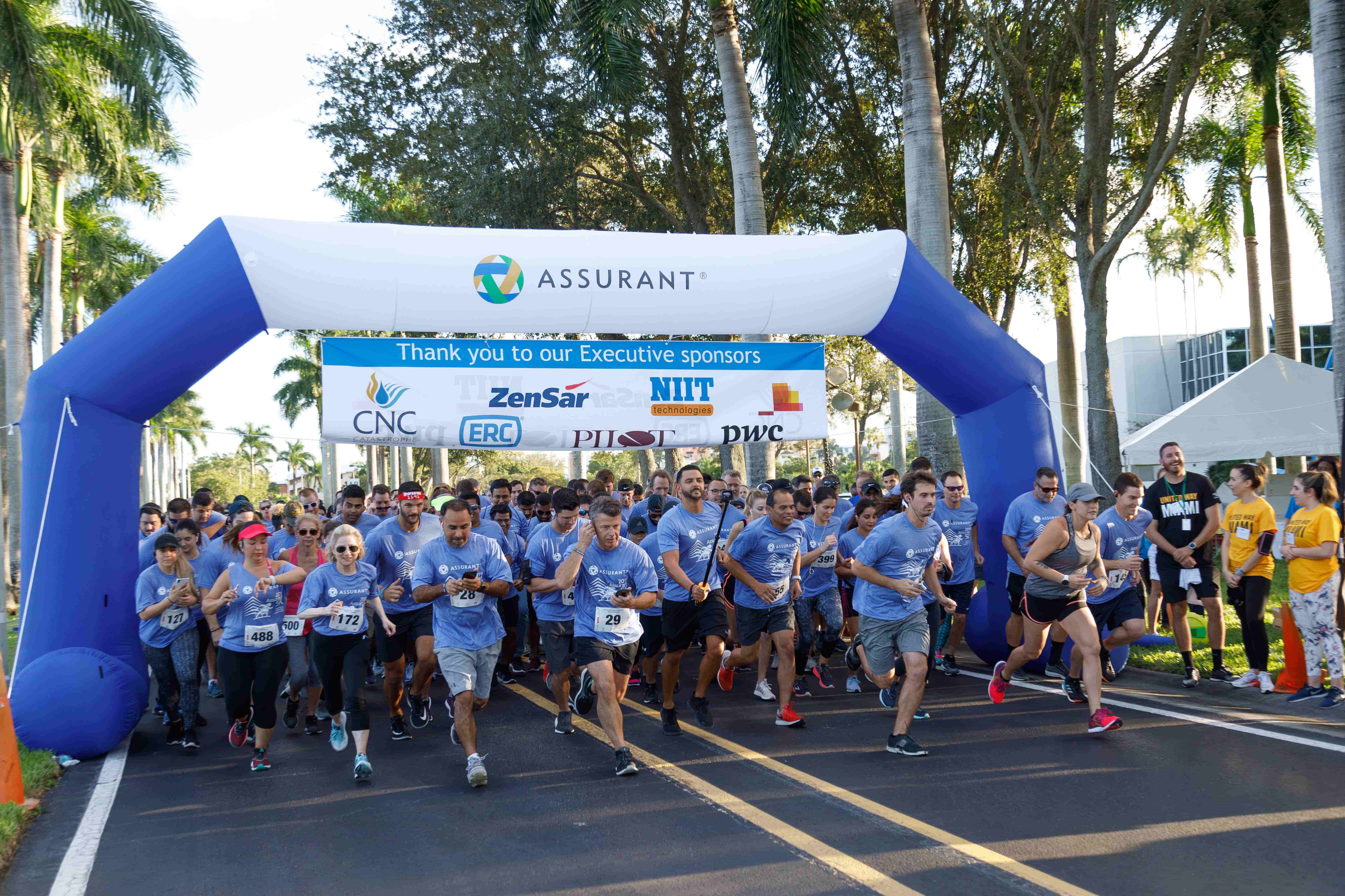 A team of Assurant employees at the starting line of a 5K race