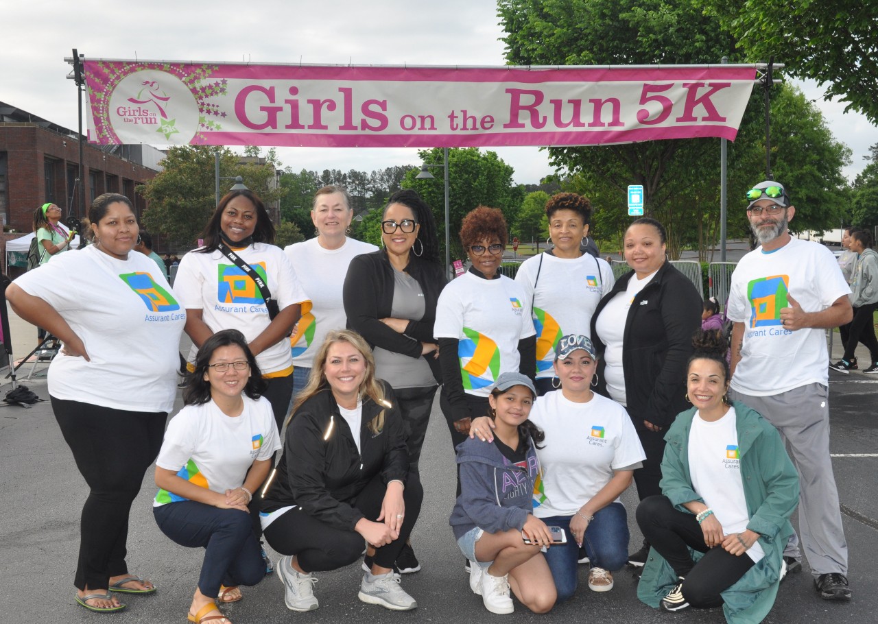 Assurant employees posing at volunteer event called Girls on the Run