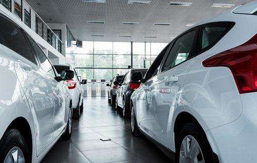 Two rows of cars lined up in a dealership