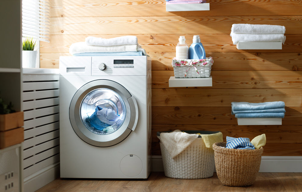 Appliance a laundry room with a basket and a washing machine